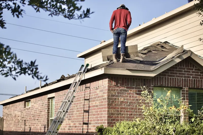 Professional roofer working on a residential roof in South Brookline